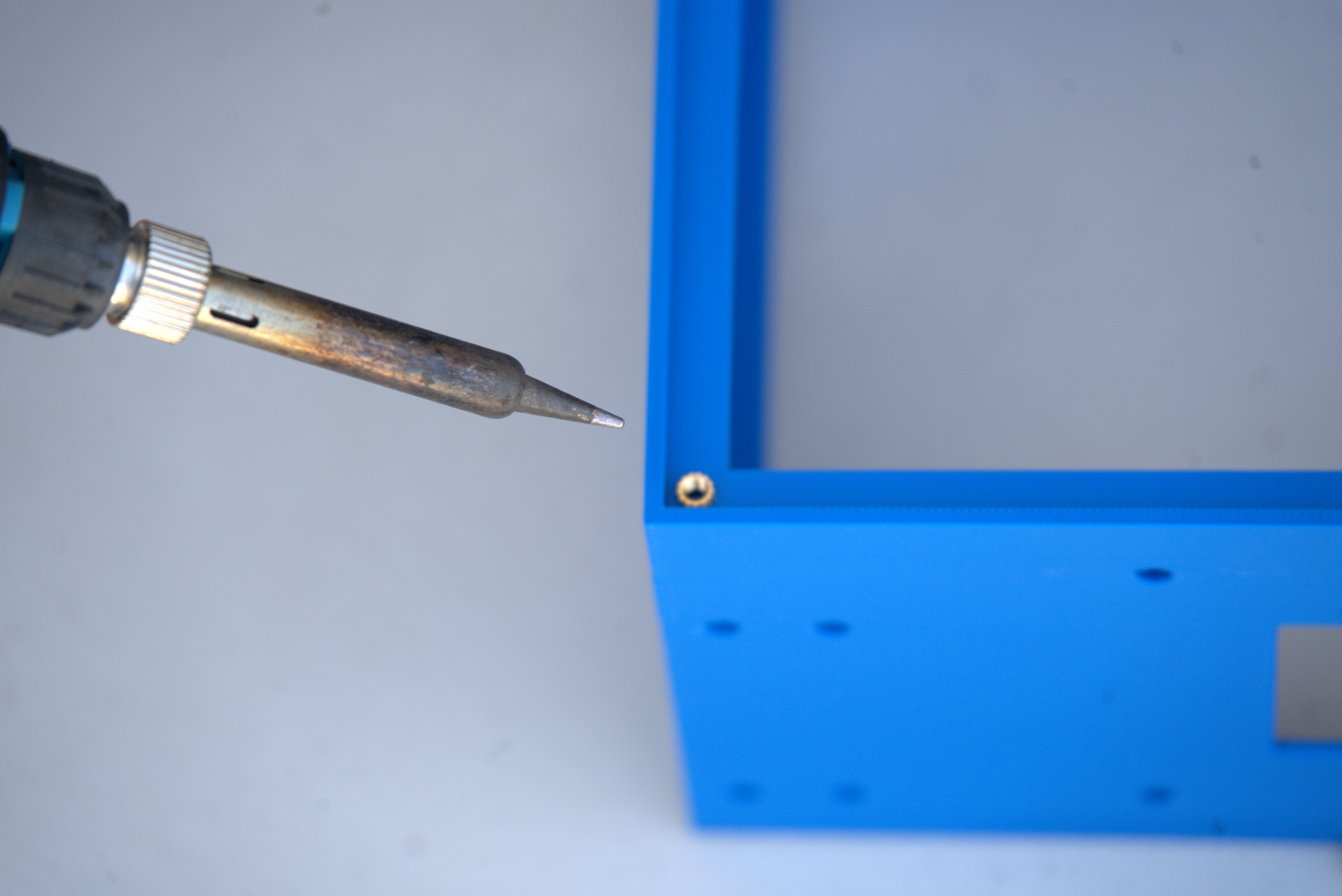 Soldering iron positioned above a heat-set insert