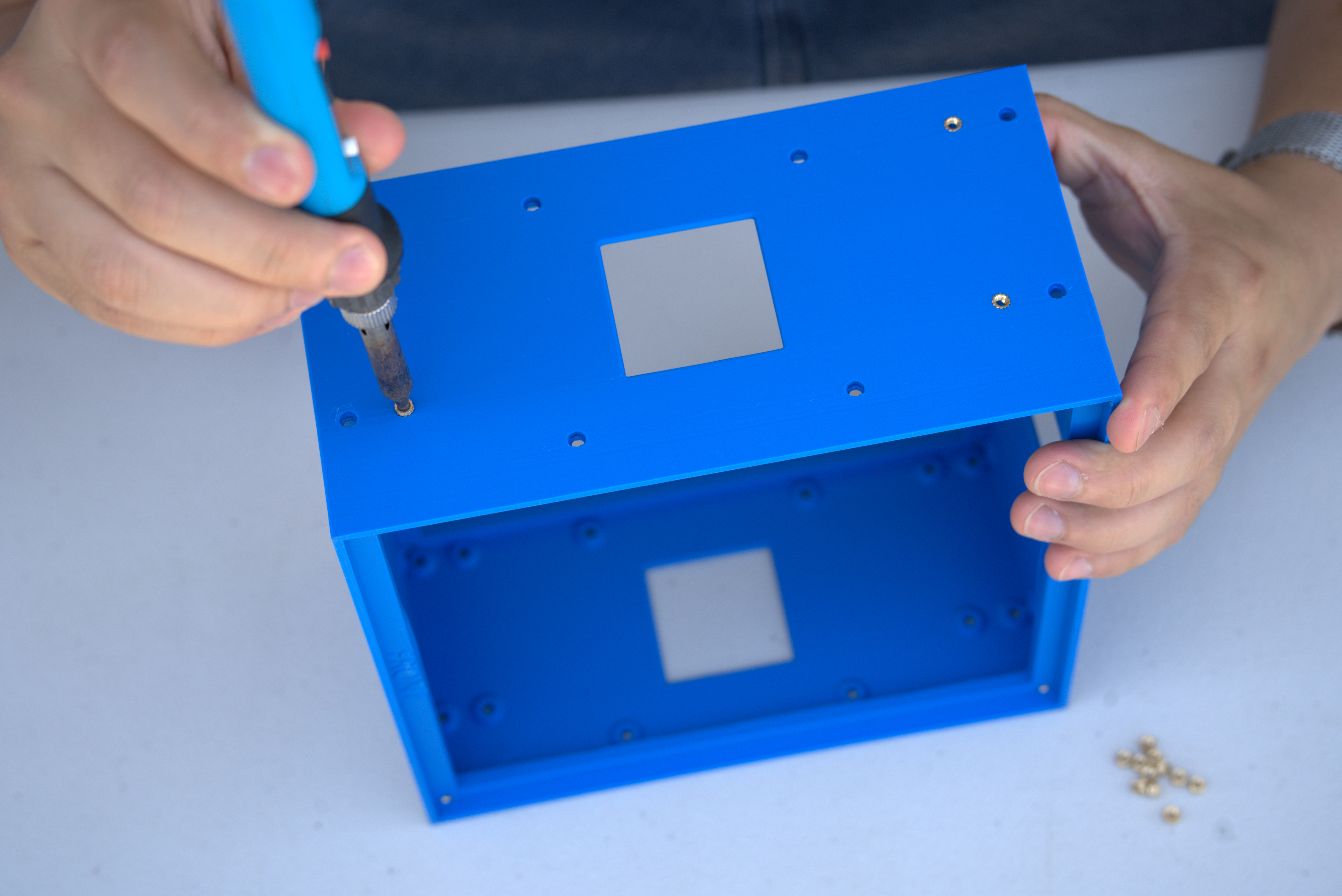Installing heat-set inserts in the side of the center chassis