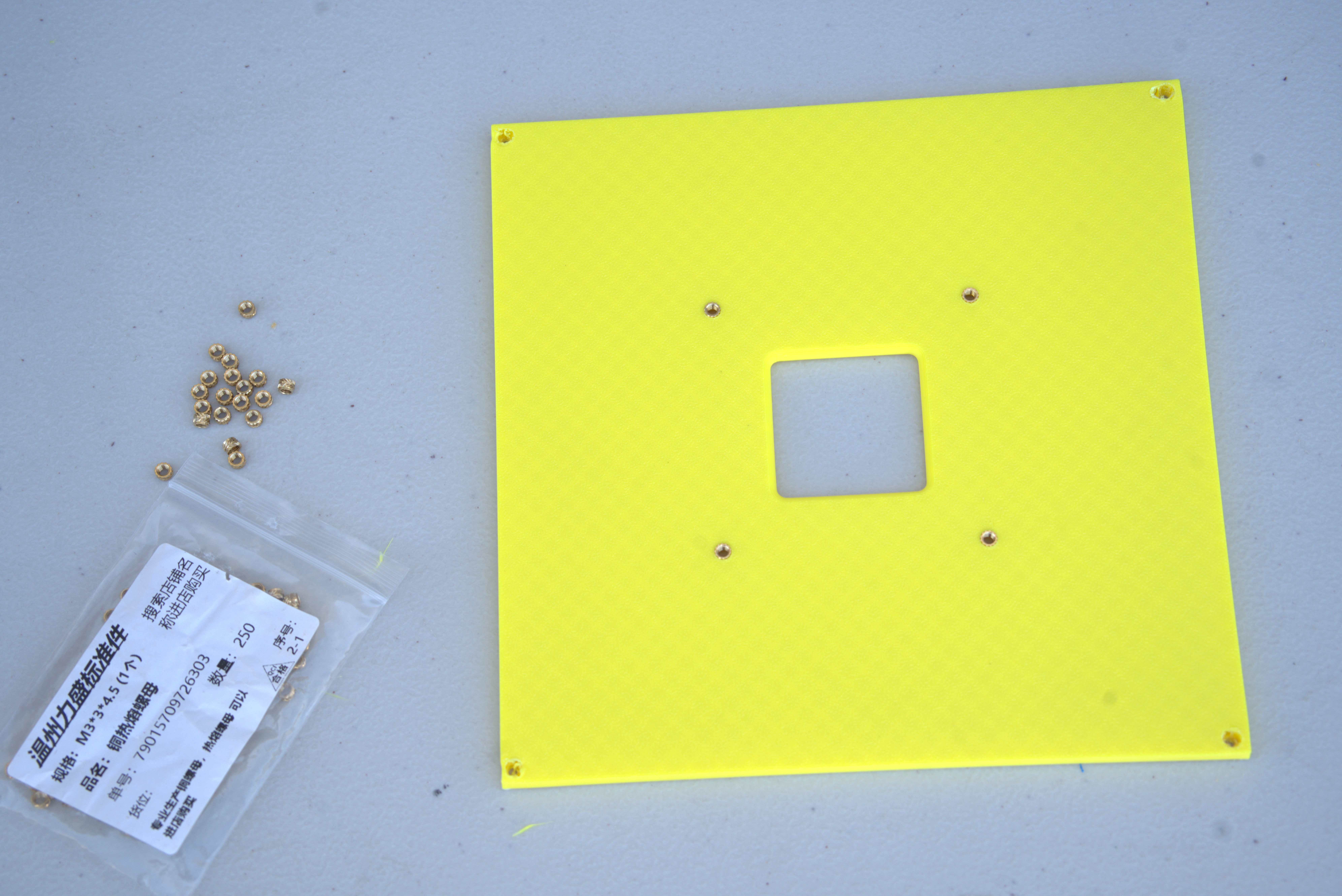 Top plate with heat-set inserts installed