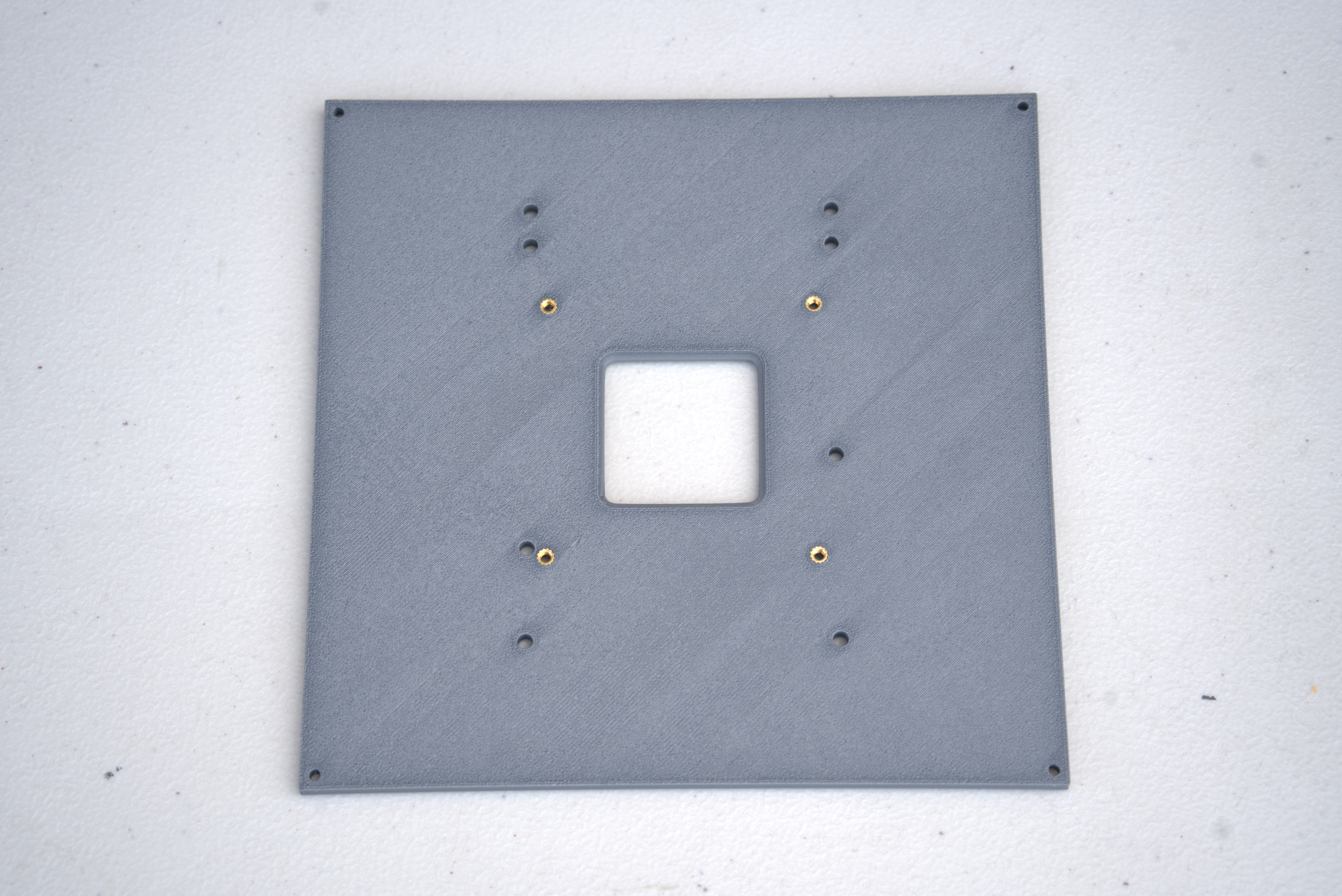 Bottom plate with heat-set inserts installed
